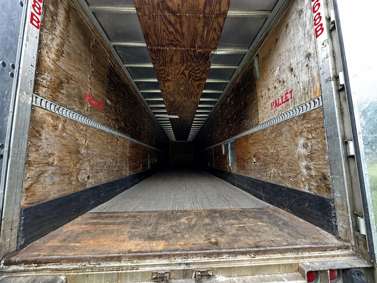 Inside a Gator Storage semi trailer — clean, plywood-lined floor and E-track for tying down your load